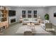 Bright living room with large windows, a fireplace, and stylish, comfortable furniture. (Virtually Staged) at 3300 Mossdale Ave, Durham, NC 27707