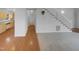 Open floor plan featuring a mix of hardwood and carpet, with a staircase and views into the kitchen at 3300 Mossdale Ave, Durham, NC 27707
