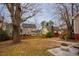 Large backyard featuring patio space and view of two-story homes at 3320 Derbyshire Pl, Raleigh, NC 27604