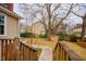 Lush backyard with mature trees, visible from a deck, creating a peaceful outdoor setting at 3320 Derbyshire Pl, Raleigh, NC 27604