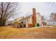 Spacious backyard featuring a deck, mature trees, and plenty of green space for outdoor activities at 3320 Derbyshire Pl, Raleigh, NC 27604