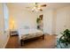 Bright bedroom with ceiling fan, neutral walls, and access to two doors at 3320 Derbyshire Pl, Raleigh, NC 27604