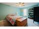 Comfortable bedroom featuring calming blue walls, plush bedding, and a mix of decor and convenient storage at 3320 Derbyshire Pl, Raleigh, NC 27604