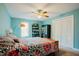 A bedroom with aqua-colored walls, neutral carpet, and a bed with a patterned comforter at 3320 Derbyshire Pl, Raleigh, NC 27604