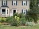 Traditional two-story home featuring a well-manicured front garden and neutral-toned siding at 3320 Derbyshire Pl, Raleigh, NC 27604