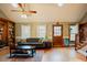 Comfortable living room featuring hardwood floors, a fireplace, and a large window with natural light at 3320 Derbyshire Pl, Raleigh, NC 27604