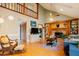 Cozy living room with fireplace, shelving, and hardwood flooring under a beamed ceiling at 3320 Derbyshire Pl, Raleigh, NC 27604