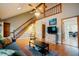 Bright living room featuring a staircase, hardwood floors, a ceiling fan, and an open layout at 3320 Derbyshire Pl, Raleigh, NC 27604