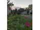 Charming street view with blooming flowers in the foreground and houses along the street at 3320 Derbyshire Pl, Raleigh, NC 27604