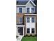 New construction townhome featuring a brick and siding exterior with large windows and a covered entry at 356 Chesapeak Commons St # 135, Garner, NC 27529