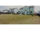 Beautiful backyard with ample green space, landscaped areas, and modern outdoor furniture at 416 Granite Saddle Dr, Rolesville, NC 27571