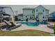 Stunning backyard featuring a pool, lounge chairs, and landscaped patio area at 416 Granite Saddle Dr, Rolesville, NC 27571