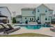 Lush backyard with a sparkling pool, outdoor seating, and meticulously maintained lawn at 416 Granite Saddle Dr, Rolesville, NC 27571