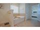 Bathroom features a soaking tub next to a window and doorway to another room at 416 Granite Saddle Dr, Rolesville, NC 27571