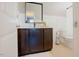 Bathroom featuring dark cabinets, a modern sink, and wainscoting at 416 Granite Saddle Dr, Rolesville, NC 27571