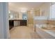 Bathroom featuring double sink vanity, soaking tub, and glass door shower at 416 Granite Saddle Dr, Rolesville, NC 27571