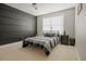 Comfortable bedroom featuring a black accent wall, ceiling fan, and soft carpeted floor at 416 Granite Saddle Dr, Rolesville, NC 27571