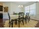 Bright dining area with wooden table and chairs, stylish rug, and modern chandelier fixture at 416 Granite Saddle Dr, Rolesville, NC 27571