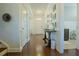 Welcoming entryway with hardwood floors, elegant console table, decorative mirrors, and views of the bathroom at 416 Granite Saddle Dr, Rolesville, NC 27571
