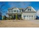 Two-story home with a covered front porch, mature landscaping, and inviting facade at 416 Granite Saddle Dr, Rolesville, NC 27571