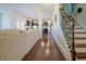 Hallway leading to an open concept kitchen with dark wood floors and staircase at 416 Granite Saddle Dr, Rolesville, NC 27571