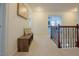 Hallway features wood banister, carpet flooring, and a storage bench next to artwork at 416 Granite Saddle Dr, Rolesville, NC 27571
