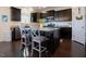 Kitchen featuring granite countertops, dark cabinets, stainless steel appliances, and a breakfast bar at 416 Granite Saddle Dr, Rolesville, NC 27571