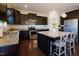 Kitchen featuring granite countertops, dark cabinets, stainless steel appliances, and breakfast bar seating at 416 Granite Saddle Dr, Rolesville, NC 27571