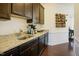 Kitchen with dark cabinets, light countertops, and stainless steel sink, plus a wooden wine rack at 416 Granite Saddle Dr, Rolesville, NC 27571
