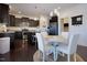 Open kitchen and dining area with dark cabinets, stainless steel appliances, and hardwood floors at 416 Granite Saddle Dr, Rolesville, NC 27571