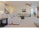 Bright living room with plush seating, a ceiling fan, and a staircase with decorative trim at 416 Granite Saddle Dr, Rolesville, NC 27571