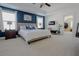 Main bedroom with tray ceiling, ceiling fan, ensuite, and large windows at 416 Granite Saddle Dr, Rolesville, NC 27571
