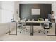 Bright office space with modern desk setup, a dark accent wall, and ample natural light at 416 Granite Saddle Dr, Rolesville, NC 27571