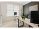 Bright office space featuring a modern desk, a black accent wall, and a sunlit window at 416 Granite Saddle Dr, Rolesville, NC 27571