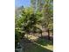 Well-maintained backyard with a charming tree, lush grass, and black metal fence at 468 Talons Rest Way, Cary, NC 27513