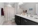 Well-lit bathroom featuring a double vanity, shower with curtain, and neutral tile floors at 468 Talons Rest Way, Cary, NC 27513