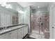 Modern bathroom features dual sinks, framed glass shower doors, and contemporary fixtures at 468 Talons Rest Way, Cary, NC 27513