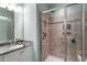 Updated bathroom featuring granite counters and a glass-enclosed tiled shower with dual shower heads at 468 Talons Rest Way, Cary, NC 27513