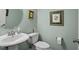 Neat half bathroom featuring a sink with a decorative framed mirror at 468 Talons Rest Way, Cary, NC 27513