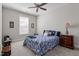 Cozy bedroom with a floral patterned bedspread and a ceiling fan for comfortable living at 468 Talons Rest Way, Cary, NC 27513