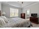 Bright bedroom features tray ceilings, fan, and en-suite bathroom access for convenience and privacy at 468 Talons Rest Way, Cary, NC 27513