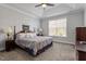 Spacious bedroom with a tray ceiling, fan, plush carpet, and bright natural light at 468 Talons Rest Way, Cary, NC 27513