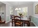 Charming breakfast area with wood table, chairs and natural light from large windows at 468 Talons Rest Way, Cary, NC 27513