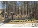 Community entrance with stone wall, landscaping and signage for 'The Creeks Weston' at 468 Talons Rest Way, Cary, NC 27513