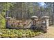 Inviting community entrance with stone wall, landscaping, and neighborhood signage at 468 Talons Rest Way, Cary, NC 27513