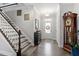 Inviting entryway featuring hardwood floors, staircase, and elegant decor leading into the home at 468 Talons Rest Way, Cary, NC 27513