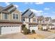 Charming townhomes featuring stone accents, siding, and attached garages in a well-maintained community at 468 Talons Rest Way, Cary, NC 27513