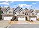 Charming townhomes with attached garages and lovely stone and siding exteriors under a blue sky at 468 Talons Rest Way, Cary, NC 27513