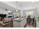 Open concept kitchen with stainless steel appliances and view to the living and breakfast areas at 468 Talons Rest Way, Cary, NC 27513