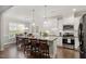 Bright, modern kitchen with white cabinetry, granite countertops, stainless steel appliances, and a dining area at 468 Talons Rest Way, Cary, NC 27513